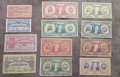 Full lot overview showing all 12 historical British Guiana Dollar banknotes (1916–1952) displayed together.