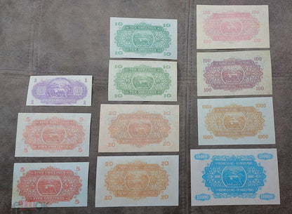 Complete lot overview showcasing all 11 historical East African Shilling banknotes (1938–1952) displayed together back