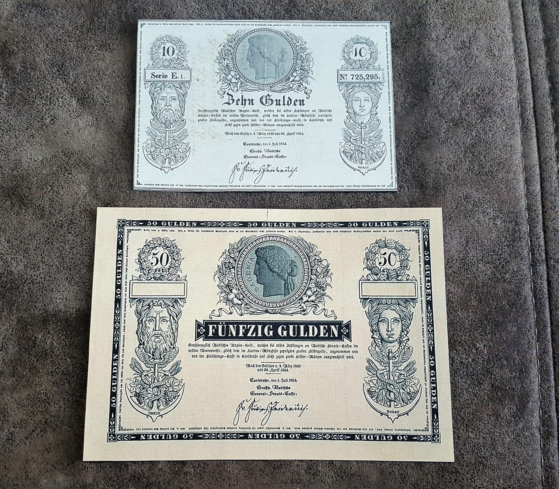 Vintage Austrian Gulden currency banknotes featuring 10 Gulden ("Zehn Gulden") and 50 Gulden ("Fünfzig Gulden") historical paper money notes with detailed ornamental engravings.