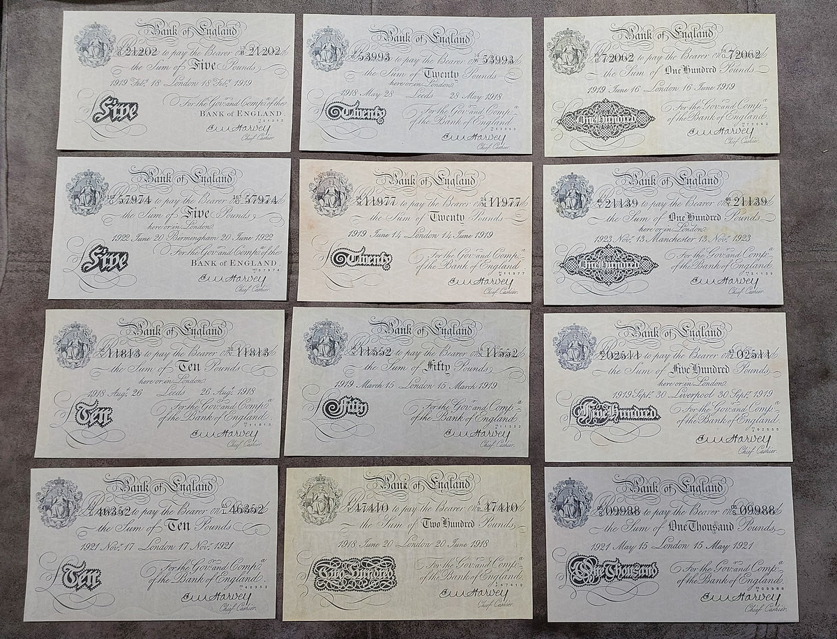 Full lot overview displaying all 12 historical Bank of England White Notes (1918–1925) arranged in a structured 3x4 grid.