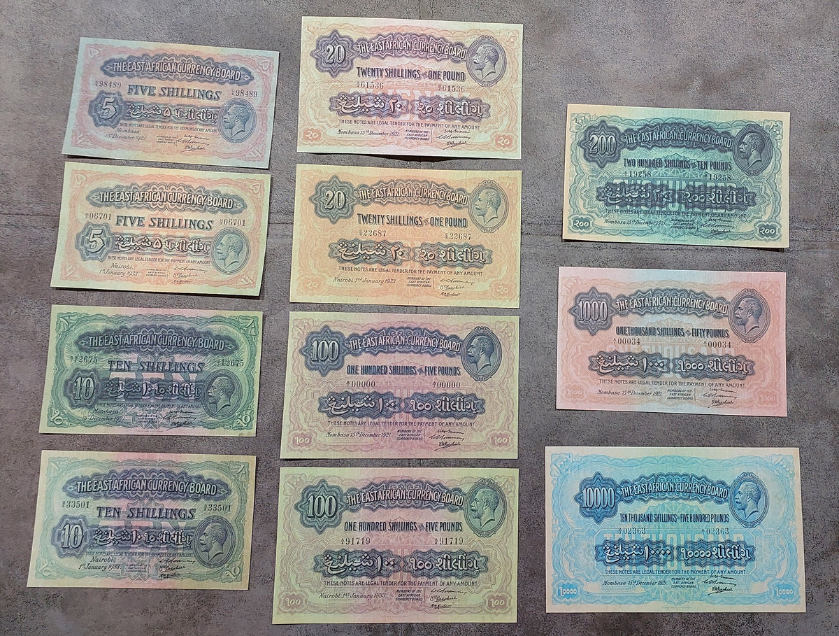 Full lot overview showcasing all 11 historical East African Shilling/Pound banknotes (1921–1933) arranged together.