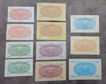 Full lot overview showcasing all 11 historical East African Shilling/Pound banknotes (1921–1933) arranged together back