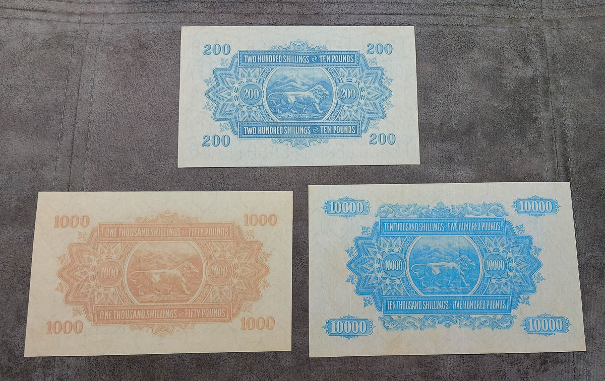 Group layout focusing on the rare high-denomination issues (200 Shillings / 10 Pounds, 1,000 Shillings / 50 Pounds, and 10,000 Shillings / 500 Pounds back