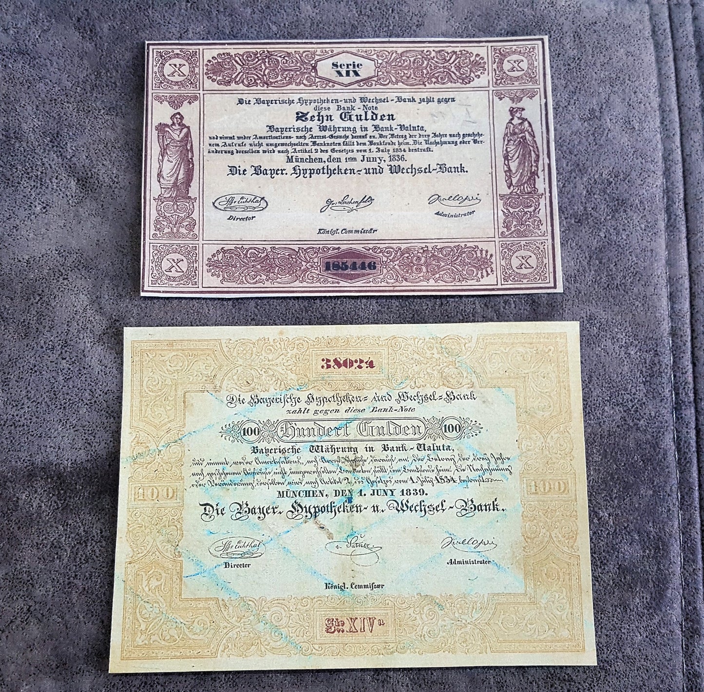 Historical German States paper money issued by Die Reichs-Hypotheken-und-Wechsel-Bank in Munich, Bavaria, featuring 10 Gulden ("Zehn Gulden") and 100 Gulden ("Einhundert Gulden") notes with ornamental borders and official signatures.