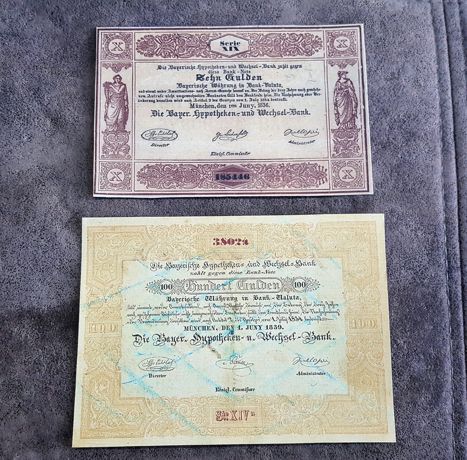 Historical German States paper money issued by Die Reichs-Hypotheken-und-Wechsel-Bank in Munich, Bavaria, featuring 10 Gulden ("Zehn Gulden") and 100 Gulden ("Einhundert Gulden") notes with ornamental borders and official signatures.