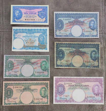 Full lot overview displaying all 7 historical Malayan banknotes (1940) arranged in a grid showing reverse side artwork and circular watermark windows