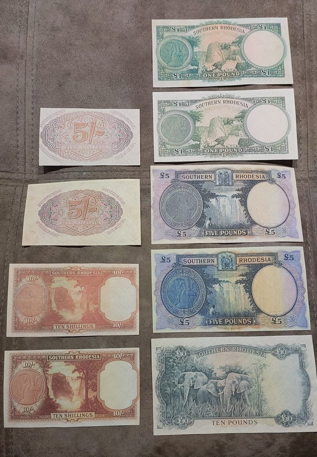 Full vertical arrangement displaying the complete sequence of Shilling and Pound banknote varieties in a structured column.
