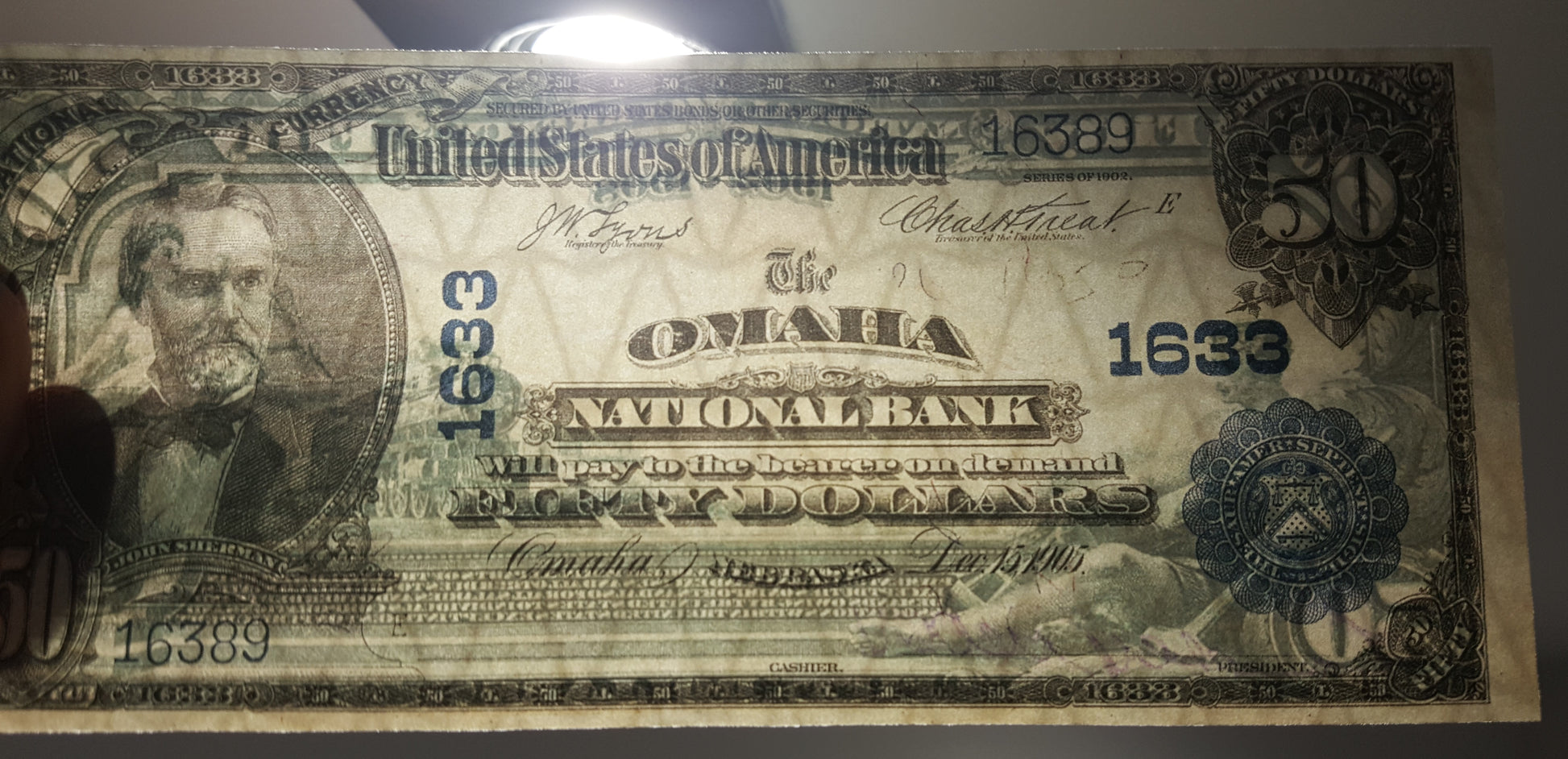 Close-up view of US National Bank Note security paper texture and watermark quality under light